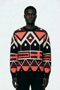 Person wearing a patterned sweater with geometric design on a white background