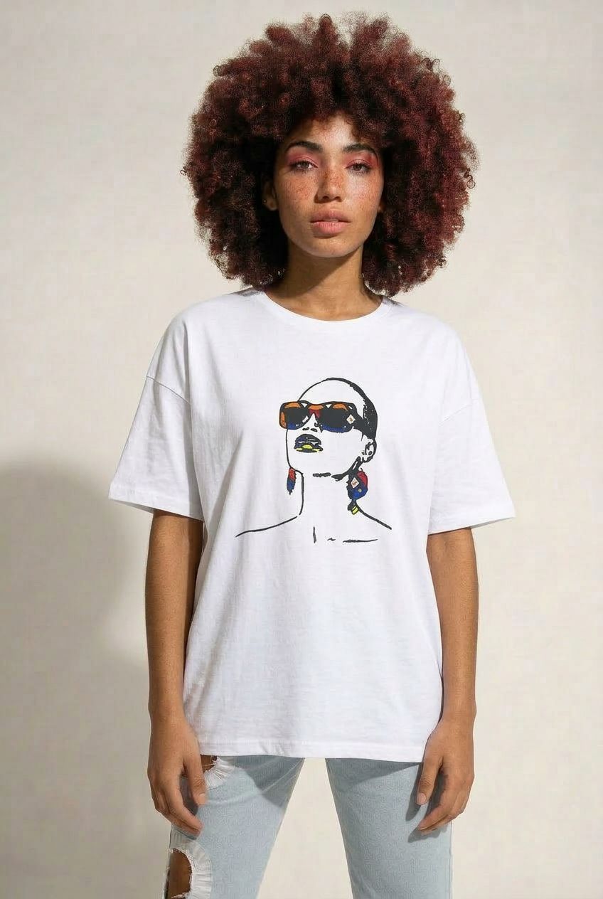 Person wearing a white t-shirt with a graphic design on a plain background