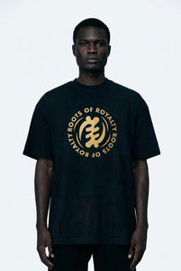 Man wearing a black t-shirt with gold logo and text on a black  background
