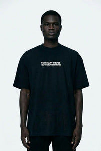 Person wearing a black t-shirt with text on a white background